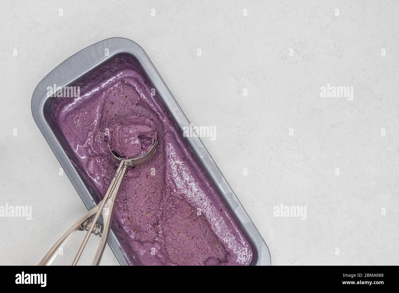 Easy homemade blackberry ice cream with metal scoop. Top view with copy space Stock Photo