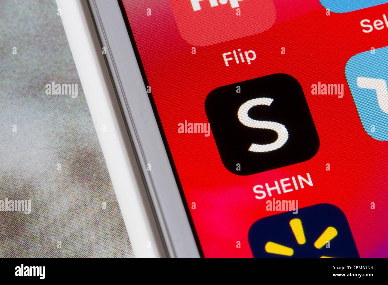 SHEIN mobile app icon is seen on an iPhone. SHEIN is an international B2C fast fashion e-commerce platform, which mainly focuses on women's wear. Stock Photo