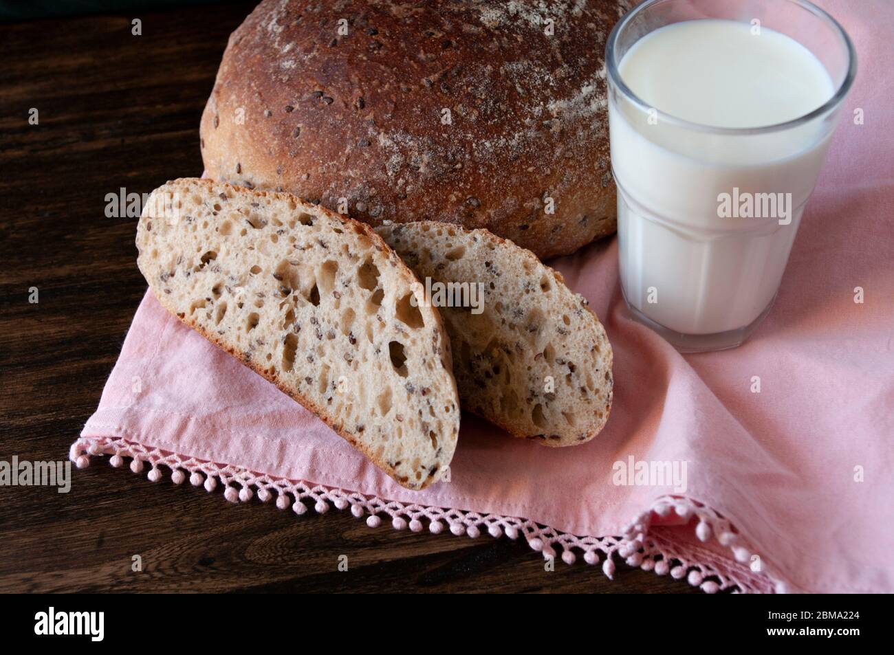 Sourdough rye bread with seeds and glass of milk. Home made bakery