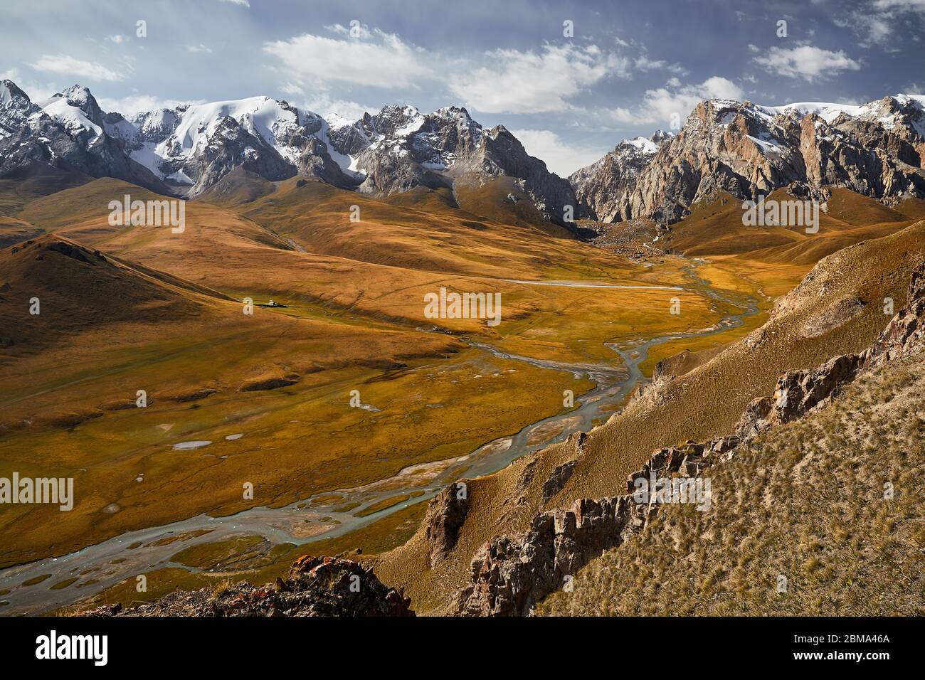 Aerial view of beautiful mountain valley with river and snow peaks near Kel Suu Lake in Naryn region, Kyrgyzstan Stock Photo