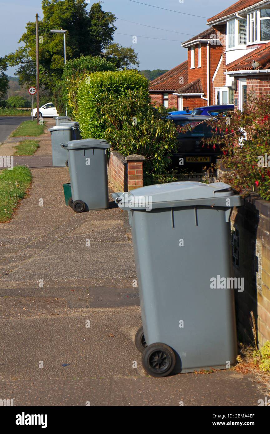Grey recycle bins outside properties awaiting collection in a residential area of Hellesdon, Norfolk, England, United Kingdom, Europe Stock Photo