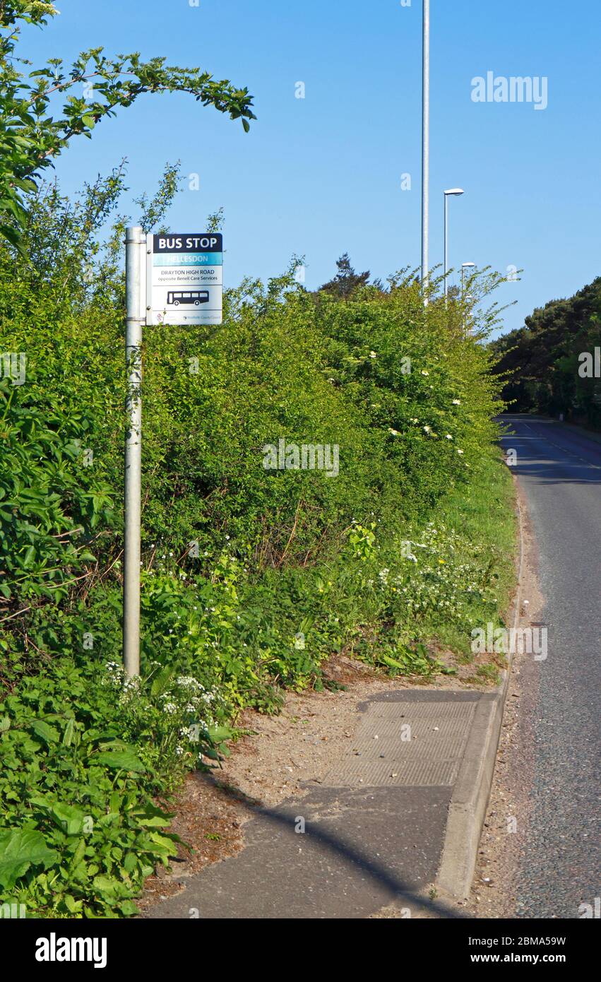 A roadside bus stop providing travel services on the A1067 road in Hellesdon, Norfolk, England, United Kingdom, Europe. Stock Photo