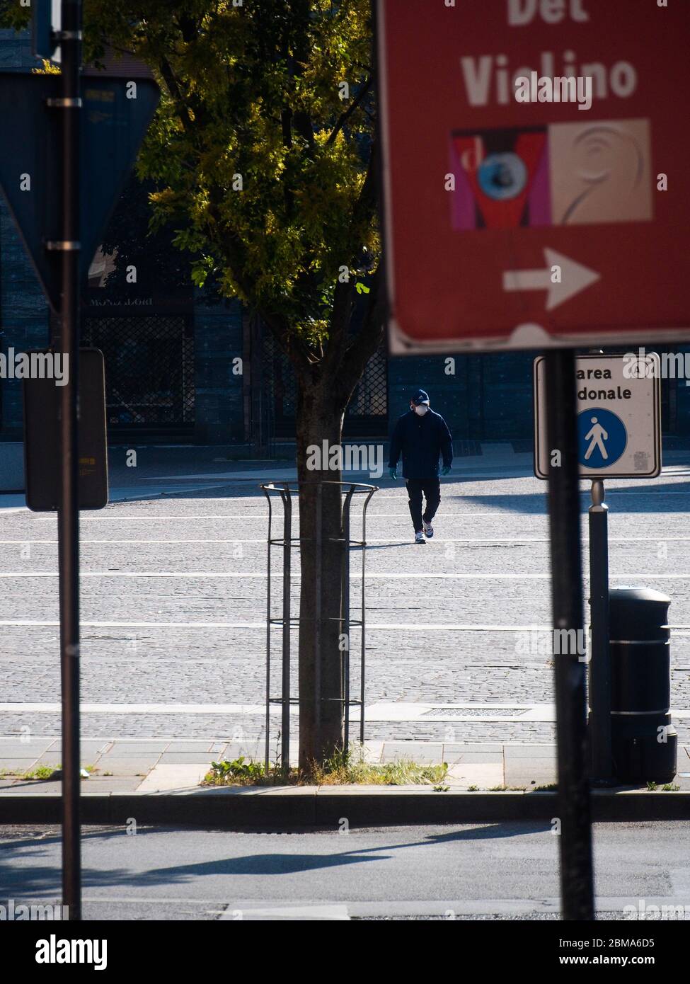 Cremona, Lombardy, Italy - May  5 6 7  2020 - Man walking alone in desertd center during coronavirus outbreak lockdown Stock Photo