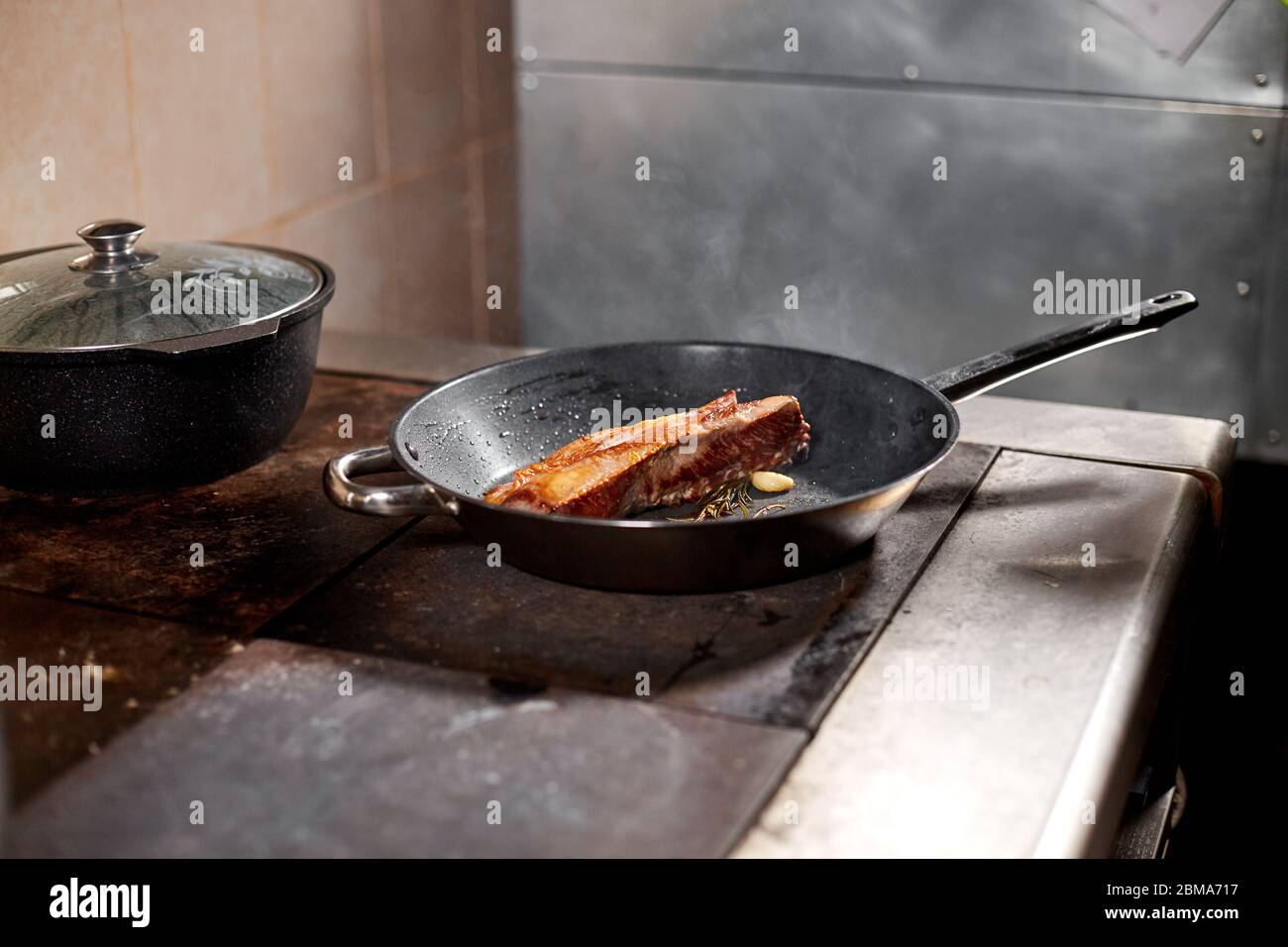Fried Ribs Of Lamb Cooking With Fire In Frying Pan Professional Chef In A Kitchen Of Restaurant Cooking Man Frying Food In Flaming Pan On Hob Stock Photo Alamy