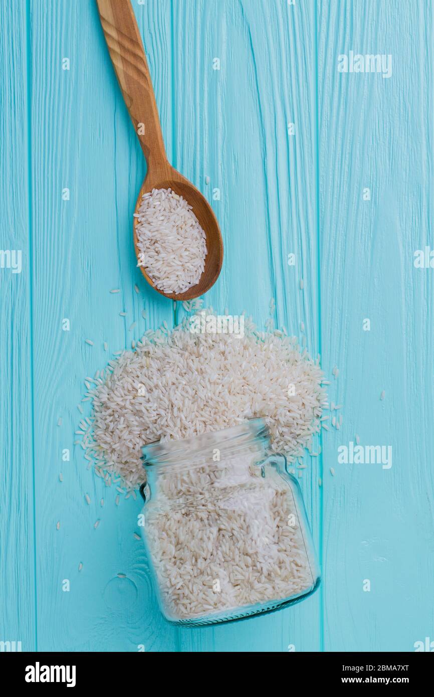White rice grains poured out of glass can Stock Photo - Alamy