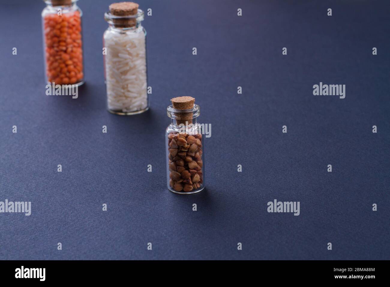 Glass containers with cork stoppers filled with grains Stock Photo Alamy