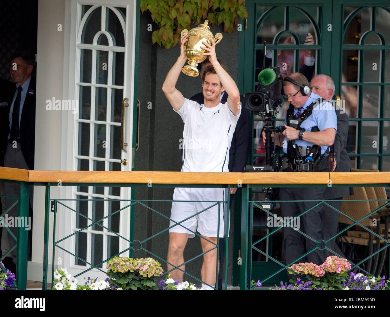 July 10th 2016, Wimbledon, London. Andy Murray holds up the Wimbledon mens singles trophy for the spectators on the balcony of the Centre Court. Stock Photo