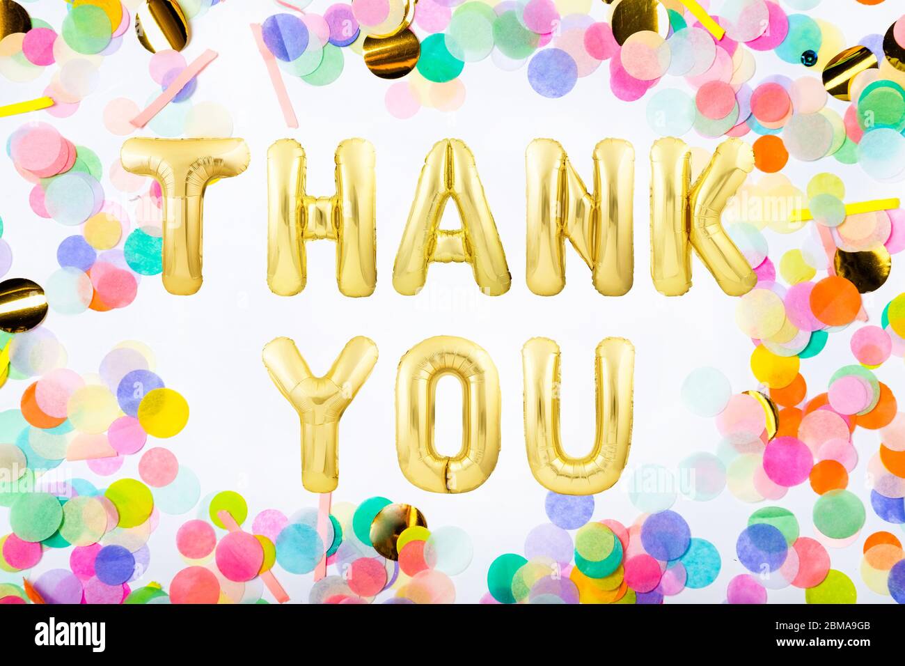 Words THANK YOU made of golden inflatable balloon letters in a frame made  of colorful confetti Stock Photo - Alamy