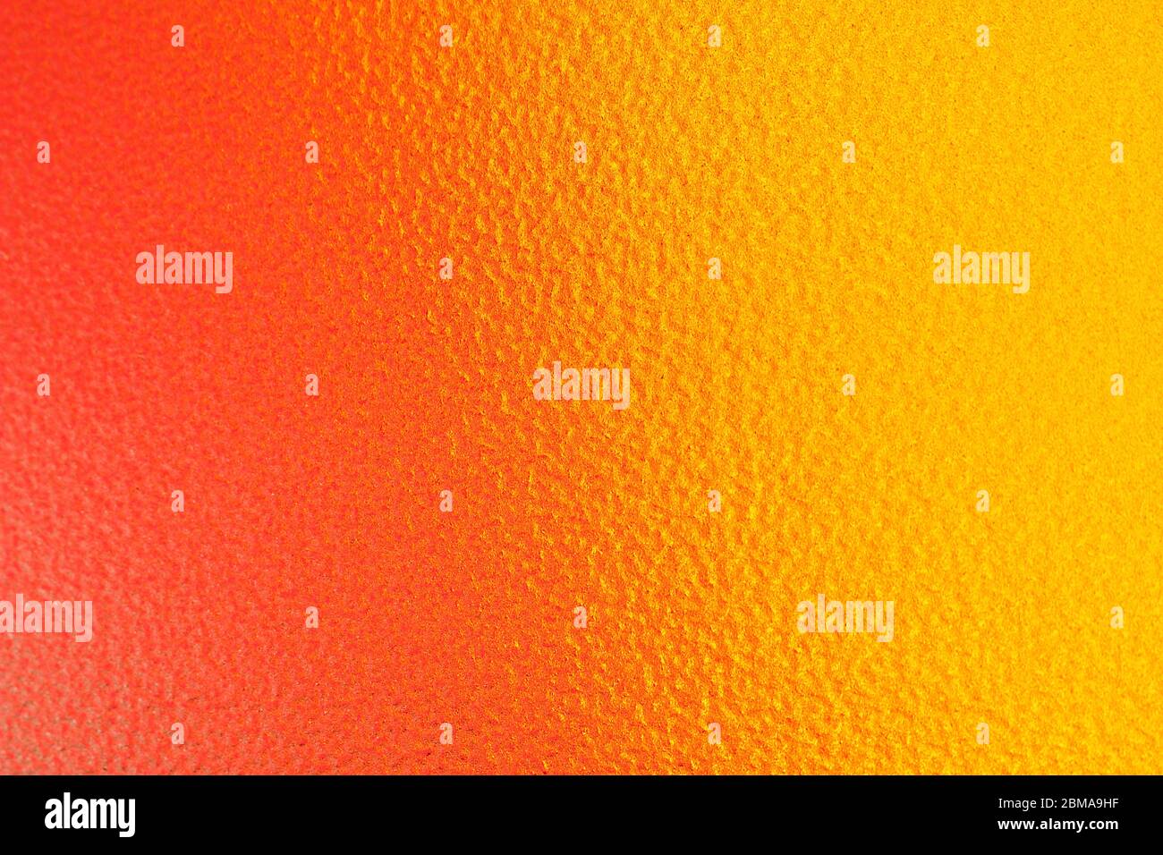 Vertical image. The background is orange, shading to a deep yellow. It have  a rough surface Stock Photo - Alamy