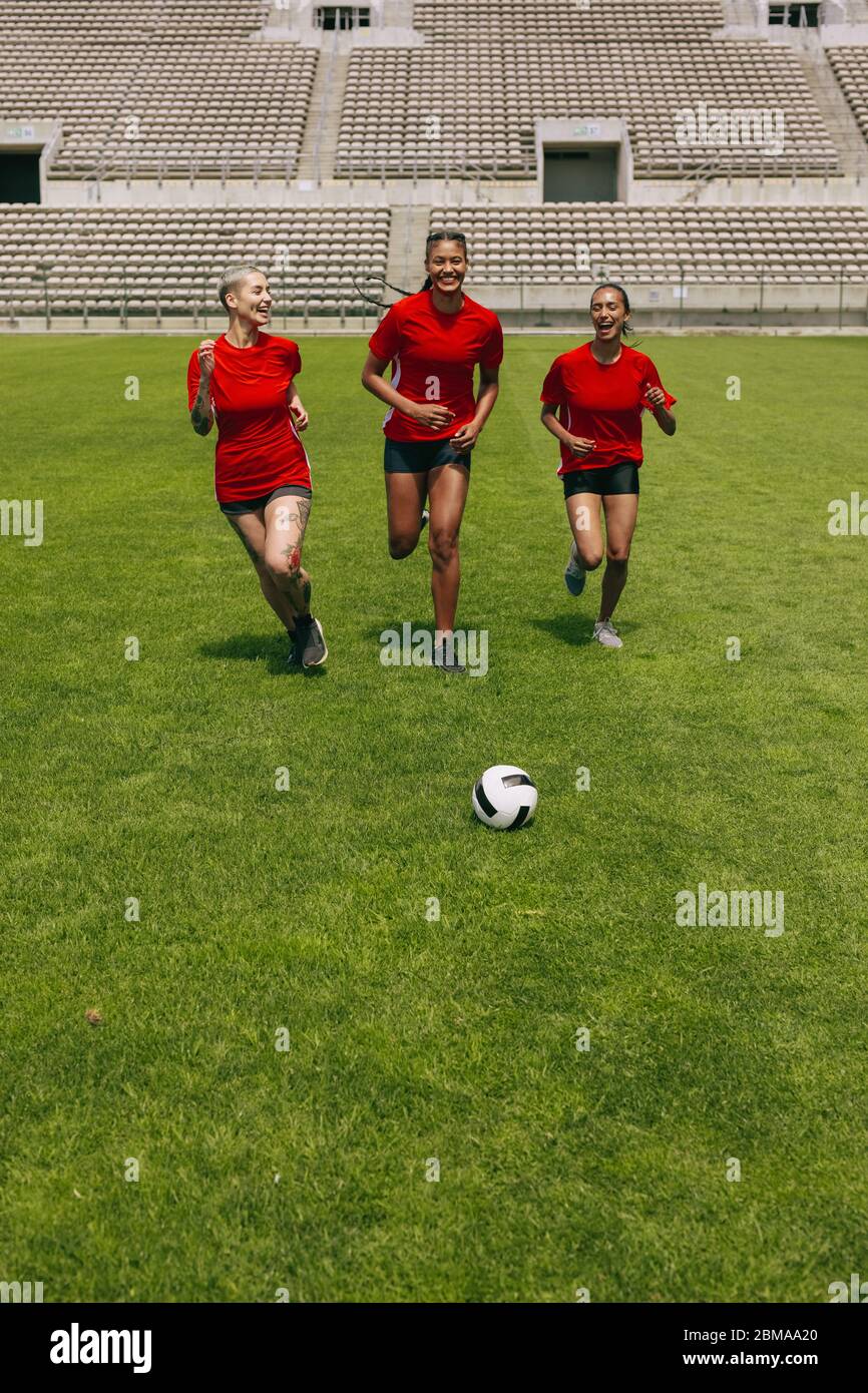 Football players training in soccer field. Female soccer team practicing during training session. Stock Photo