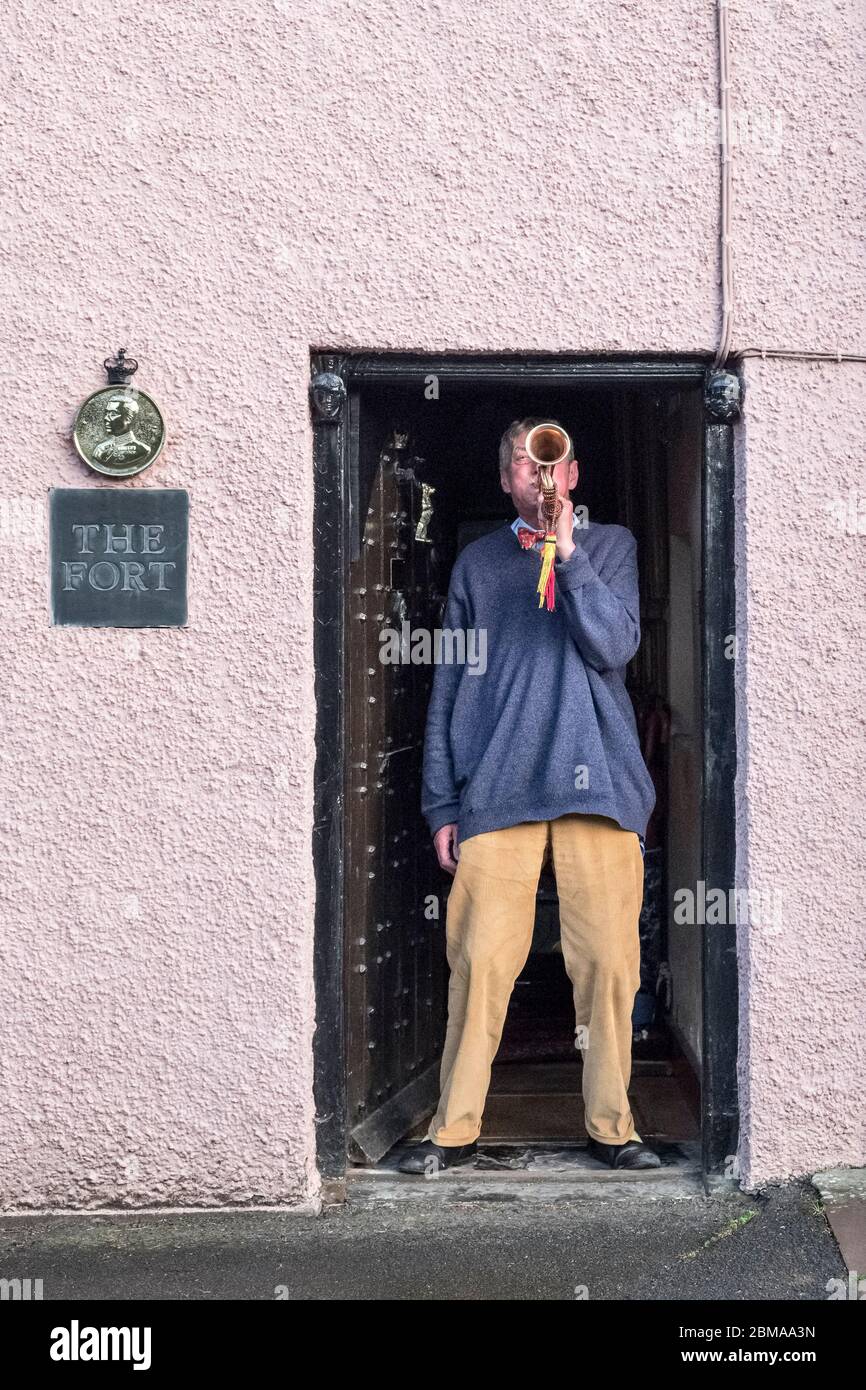 Nick Jones-Evans plays the bugle at his front door during the weekly Clap for our Carers event in Presteigne, Powys, Wales, UK Stock Photo