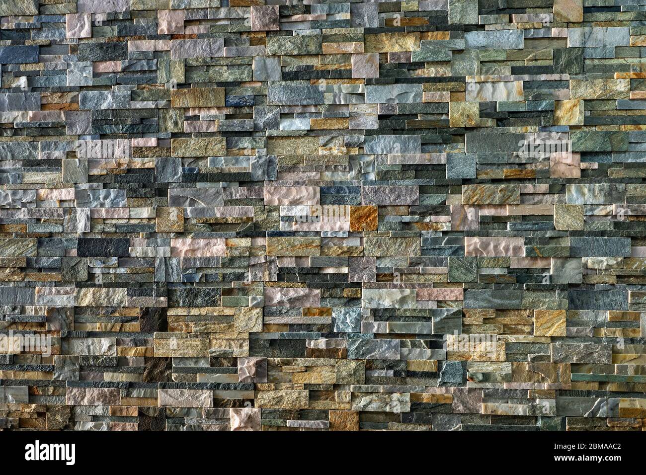 Decorative wall made of processed stones. Different types of decorative