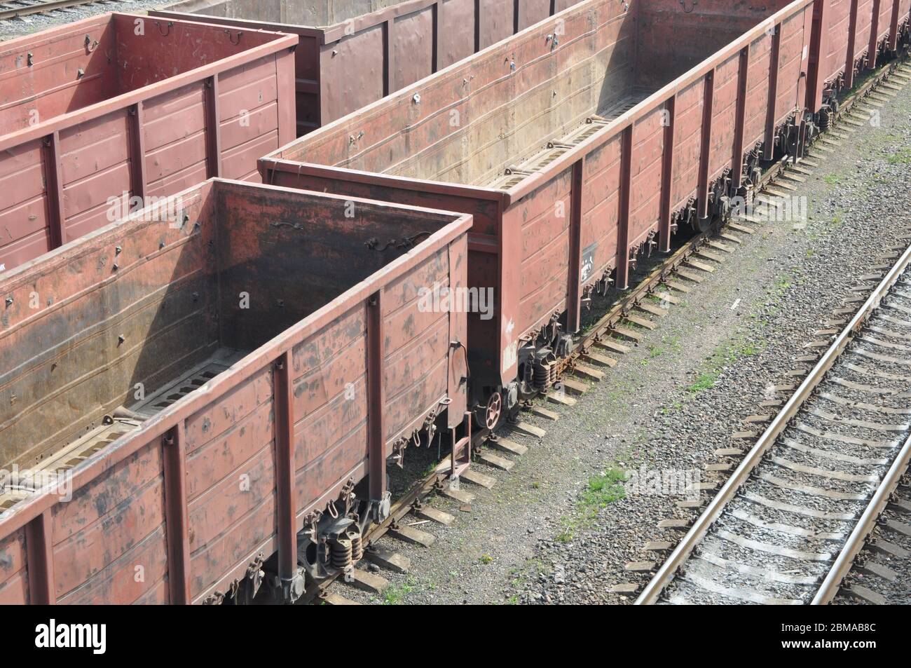 Rail freight trains are waiting in line for loading. Wagons for the transport of industrial goods. Stock Photo