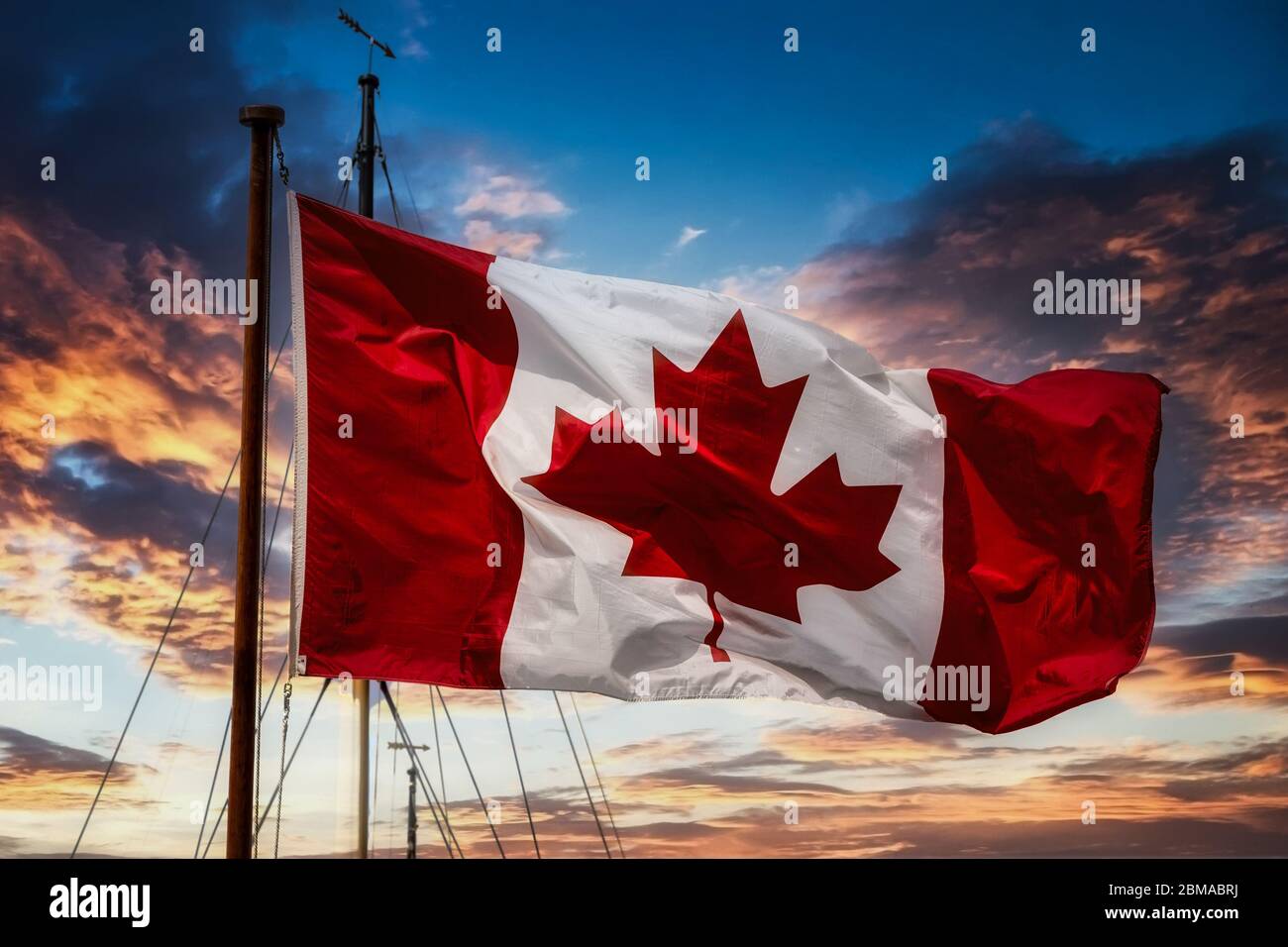 Canadian Flag on Mast at Sunset Stock Photo