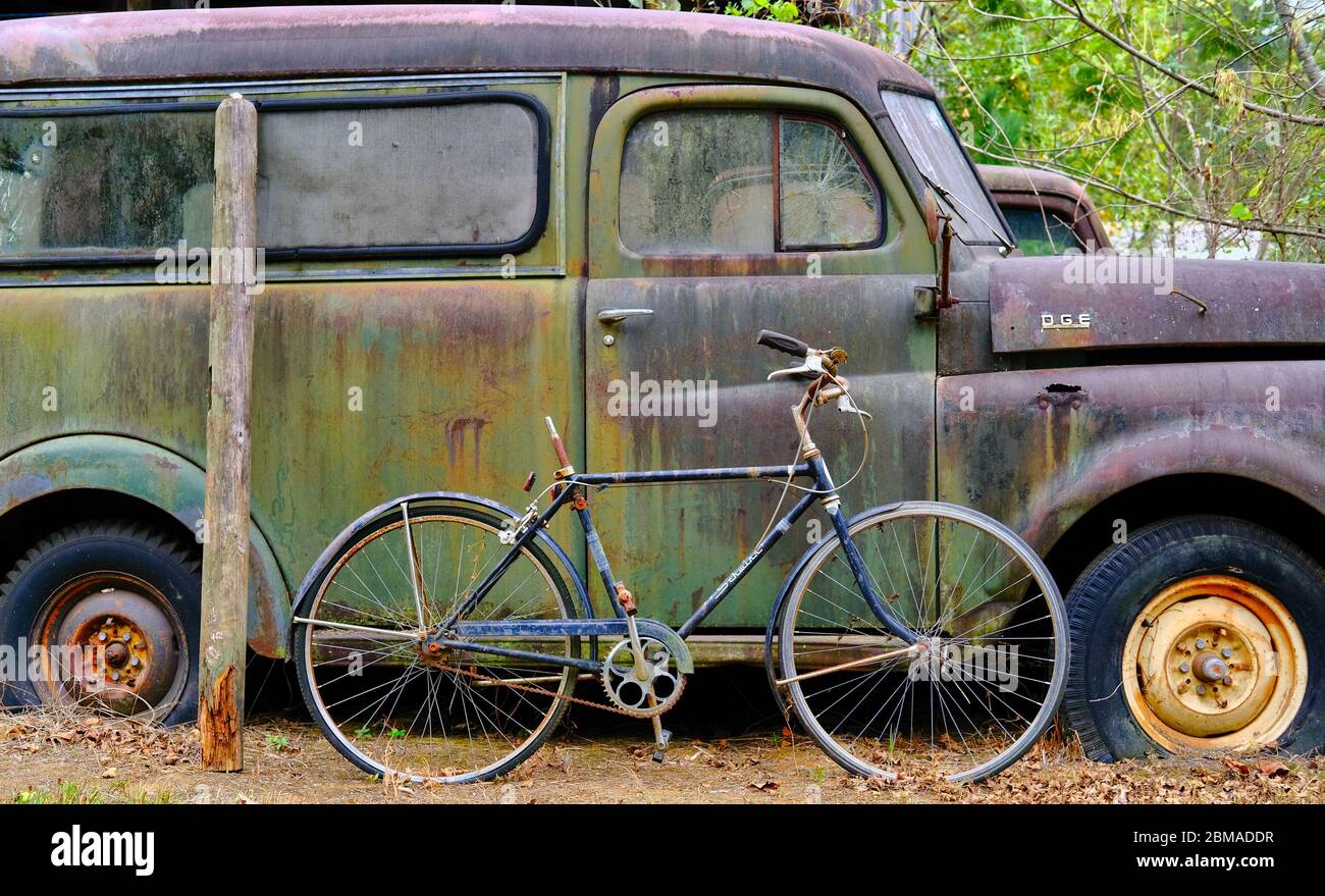 Seatless Bike Against Old Rusty Dodge Van Stock Photo
