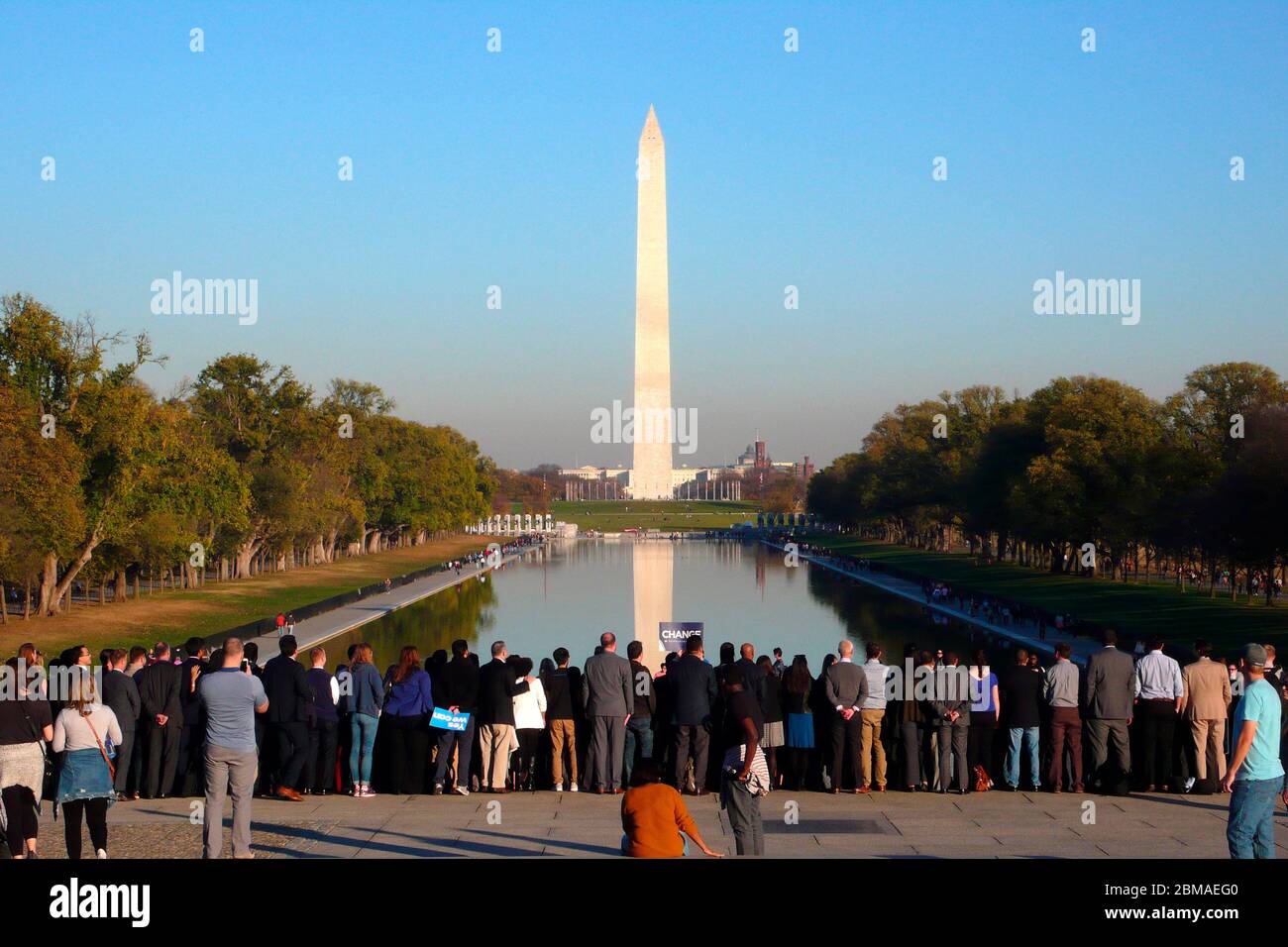 Gathered crowd and The Washington Monument from the Lincoln Memorial Reflecting Pool and capitol building in far distance, Washington DC,USA Stock Photo