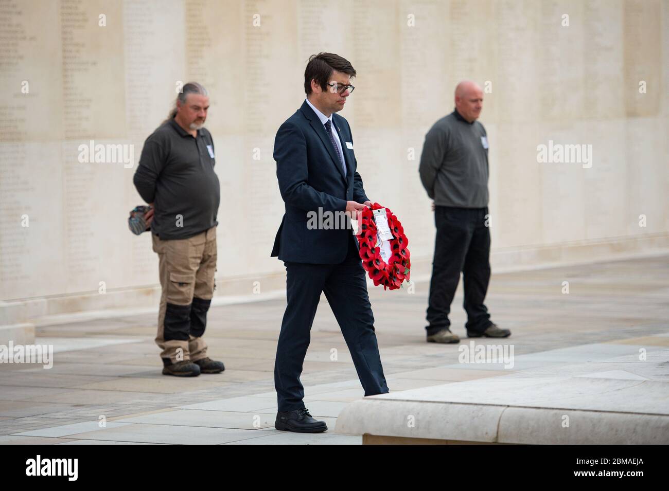 Staff at the deserted National Memorial Arboretum in Alrewas, Staffordshire, observe a two minutes' silence to commemorate the 75th anniversary of VE Day. Mark Ellis, head of visitor experience, laid a wreath. Normally the Arboretum would welcome around 10,000 visitors to mark such an occasion. Stock Photo