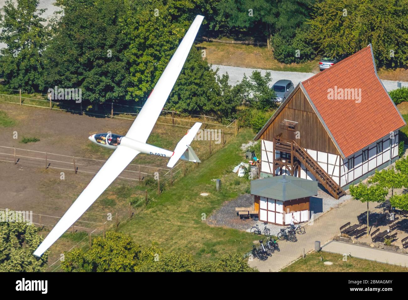 sailplane ASK21 in flight over restaurant Restaurant Altes Faehrhaus, training of landing, 04.08.2019, aerial view, Germany, North Rhine-Westphalia, Ruhr Area, Hamm Stock Photo