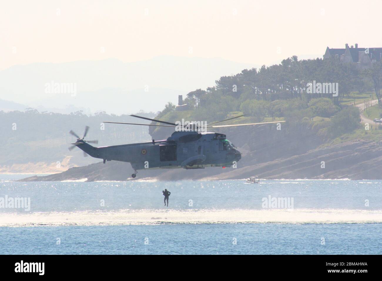 Series 2 of 165 Sikorsky SH-3 Sea King dropping diver into the sea at the Armed Forces Day Santander Spain Stock Photo