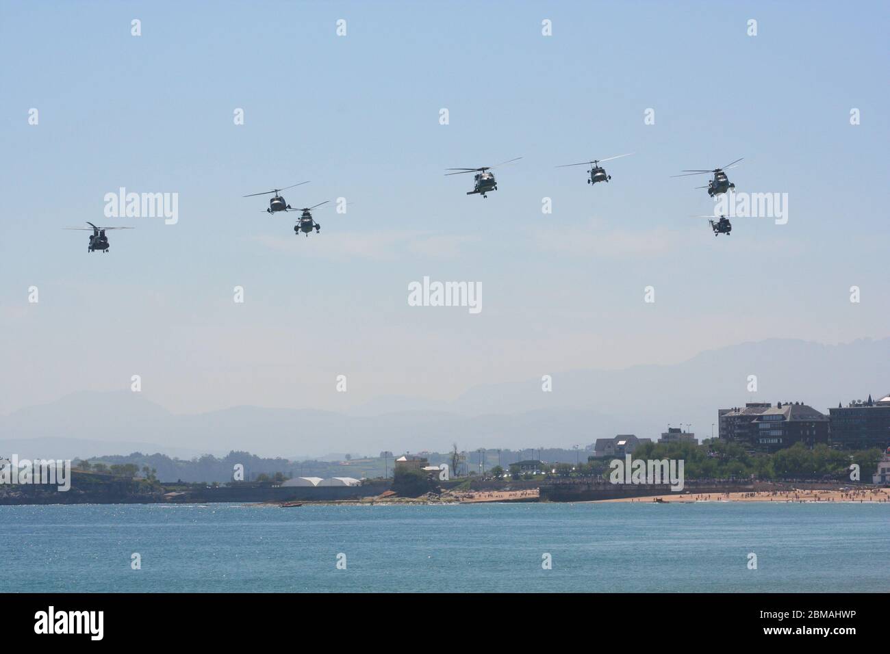 Series 100 of 165 Seven helicopter fly past at low level at the Armed Forces Day Santander Spain Stock Photo