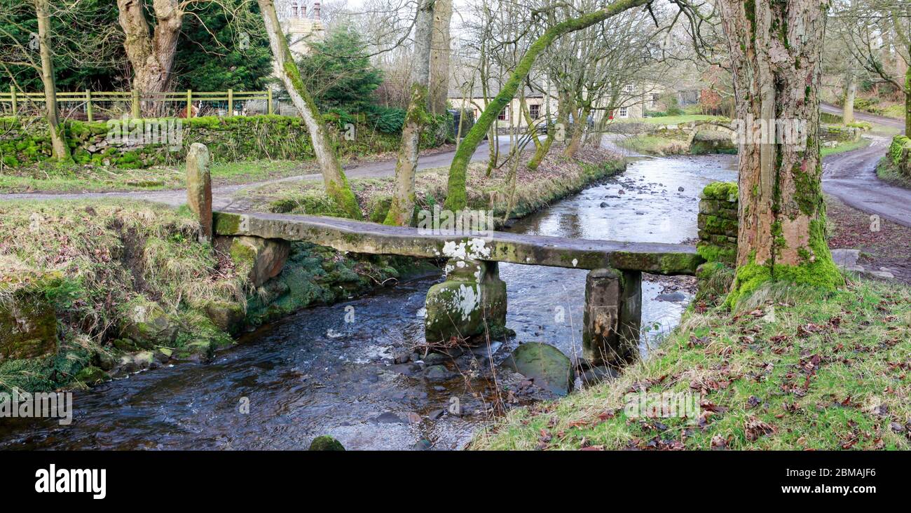 An ancient clapper bridge over Wycoller  Beck in Wycoller Country Park, Pendle, Lancashire, England Stock Photo