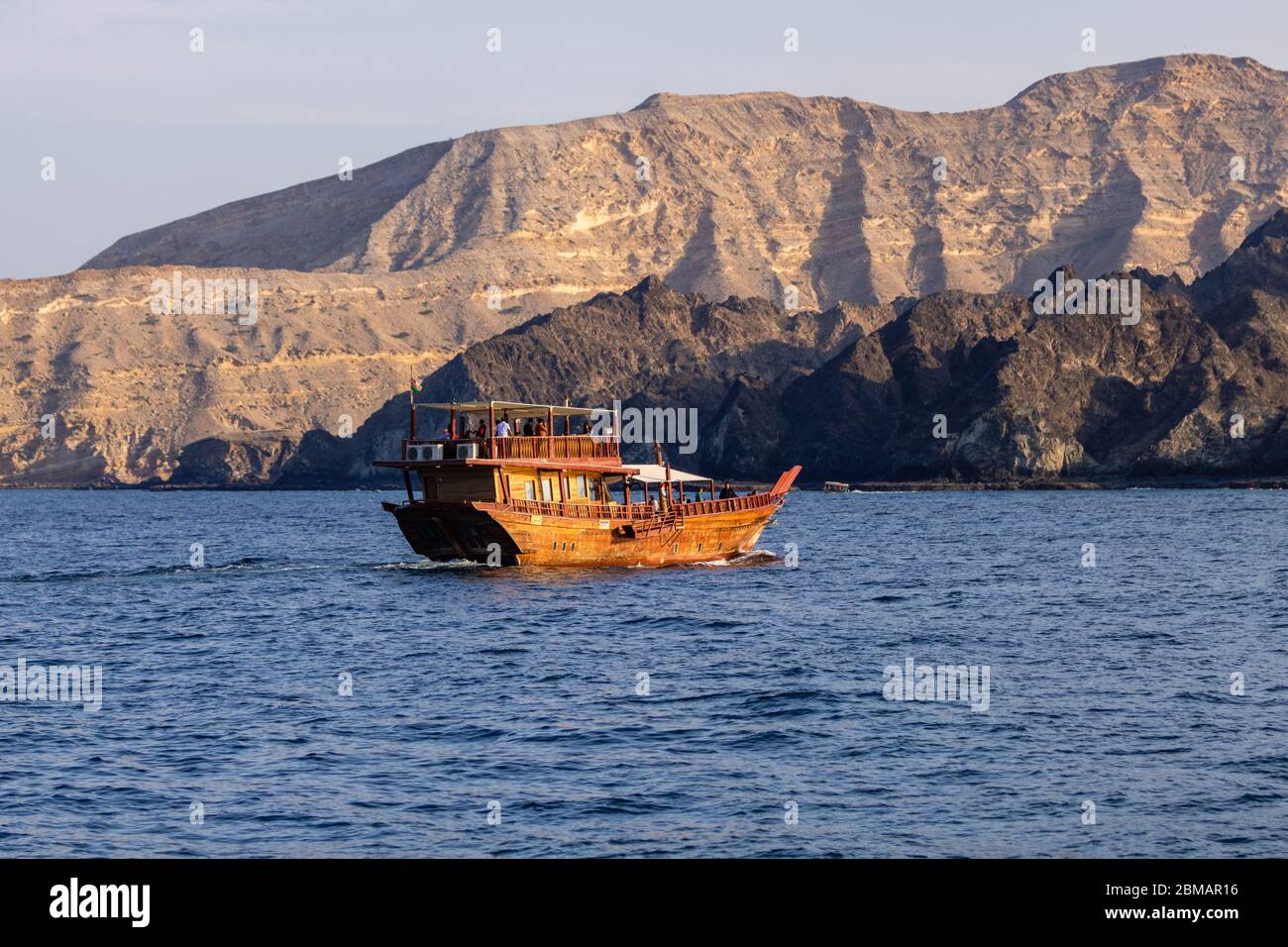 Dhow cruise during sunset in deep blue ocean as entertainment and tourism activity Stock Photo