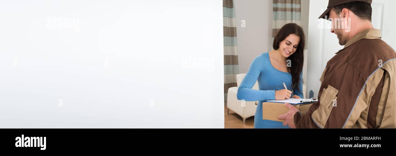 Happy Woman Receiving Package From Delivery Courier Man Stock Photo