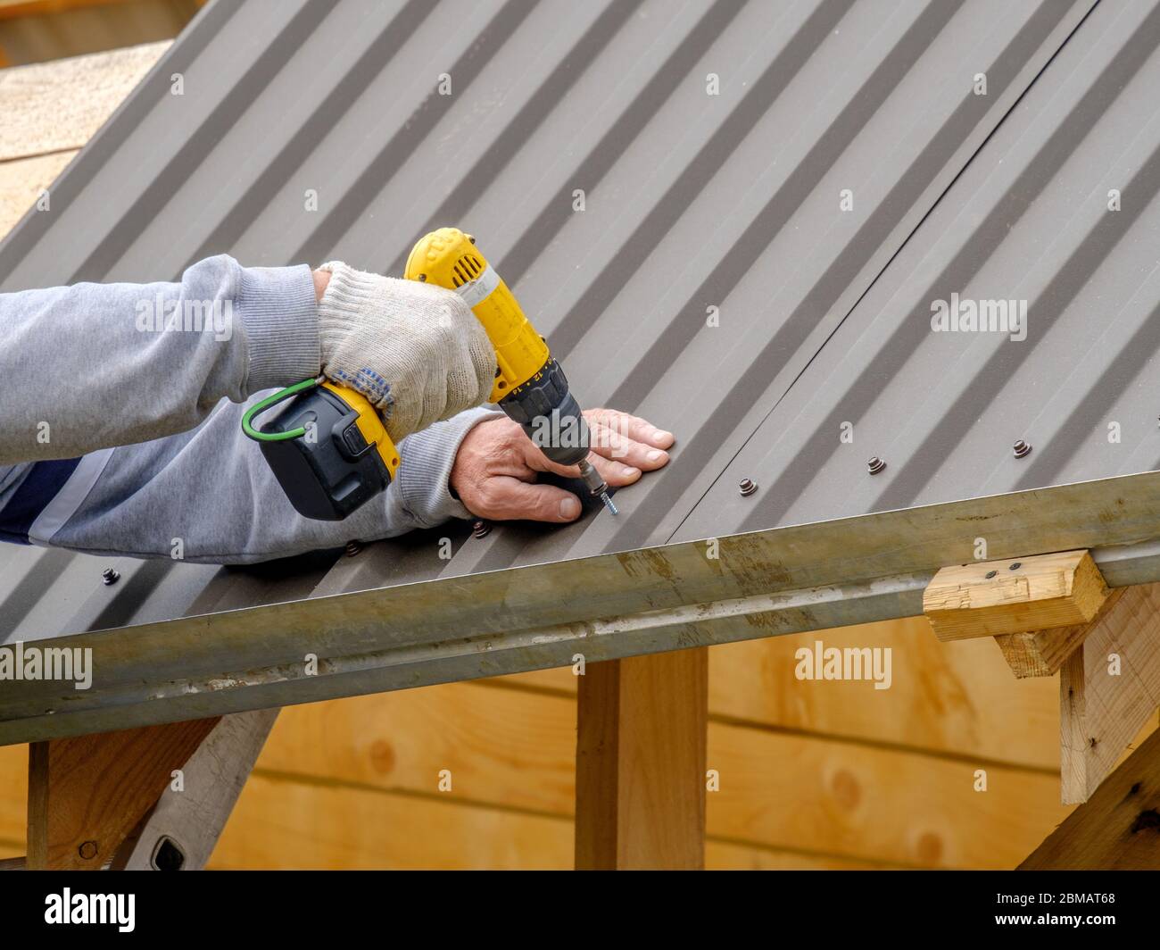 Men's Hands Work Gloves Yellow Screwdriver Screw Roofing Sheet Roof Stock  Photo by ©e.a.nekrasov 370906520