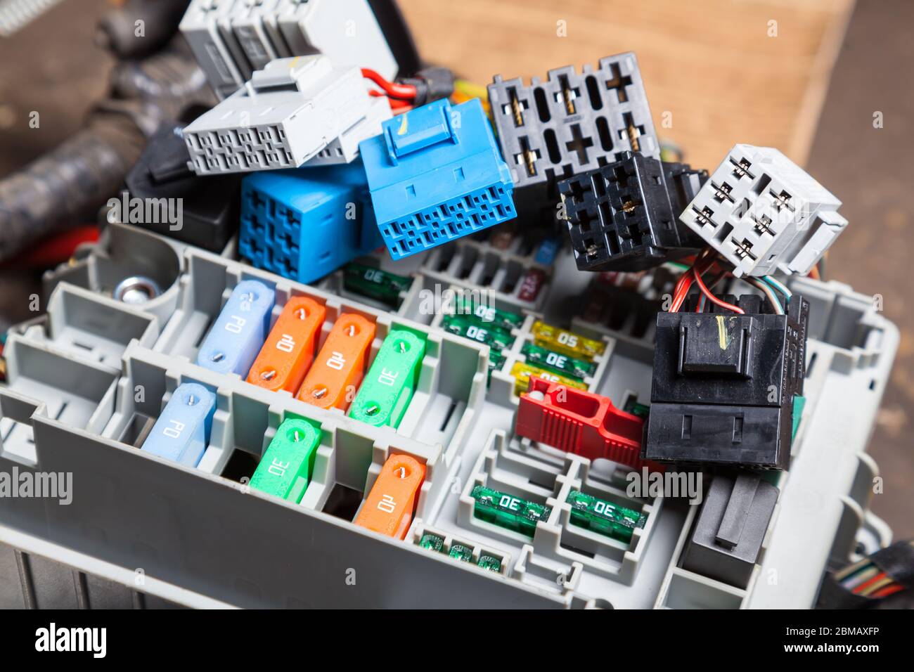 Automotive fuses on the panel with connectors and multicolored marked