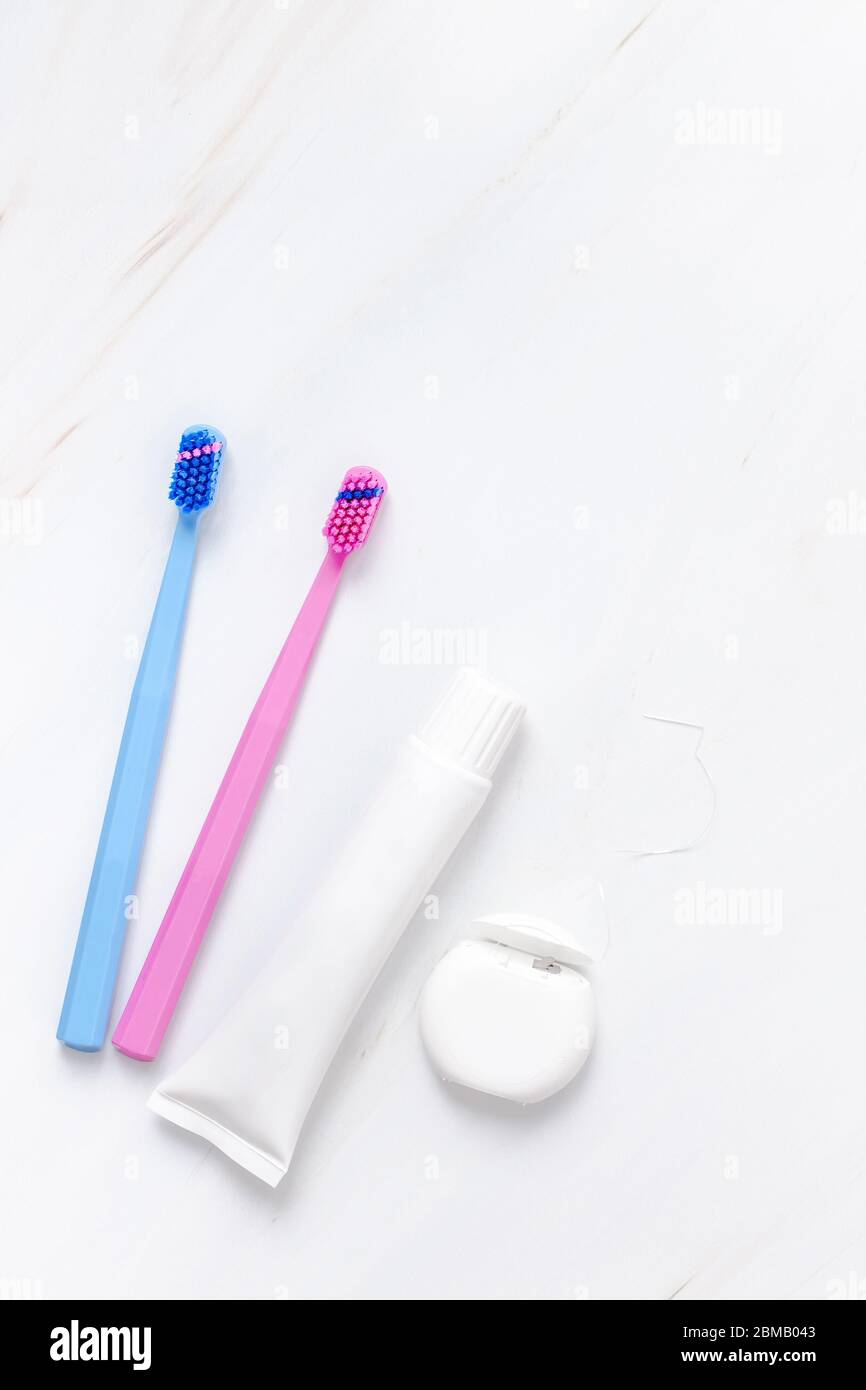Teeth hygiene and oral dental care products on white marble table ...