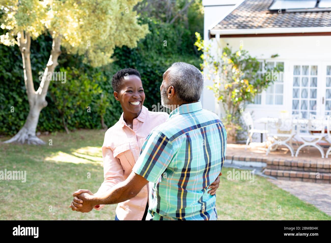 Senior African American couple dancing in their garden Stock Photo - Alamy
