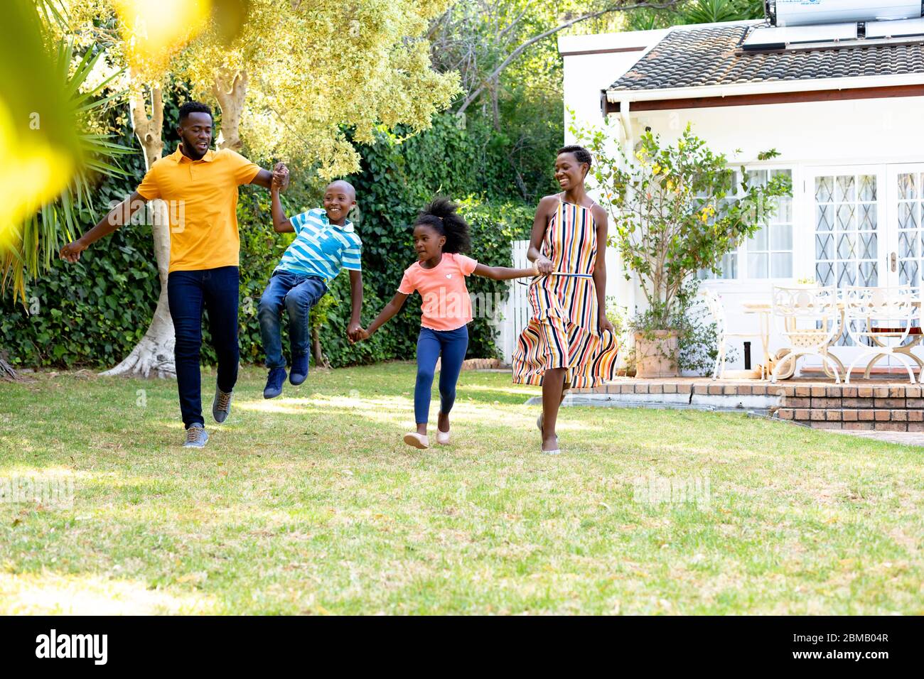African American family spending time together in their garden. Stock Photo