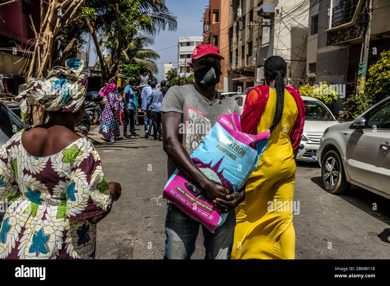 Dakar, Senegal. 7th May, 2020. A man receives a bag of rice for his family in Dakar, Senegal, on