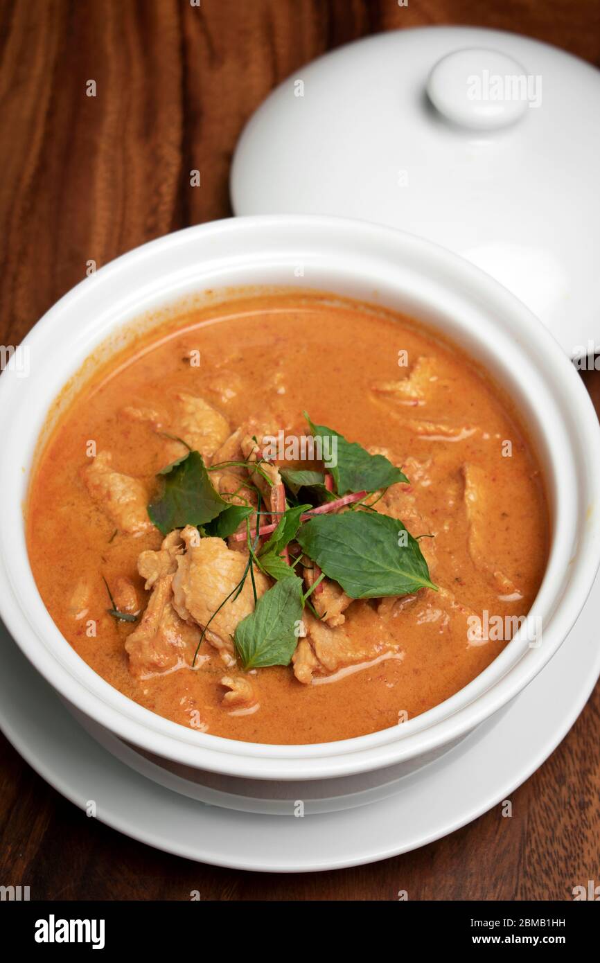 thai spicy panang pork curry with coconut milk on wood table in Phuket Thailand Stock Photo