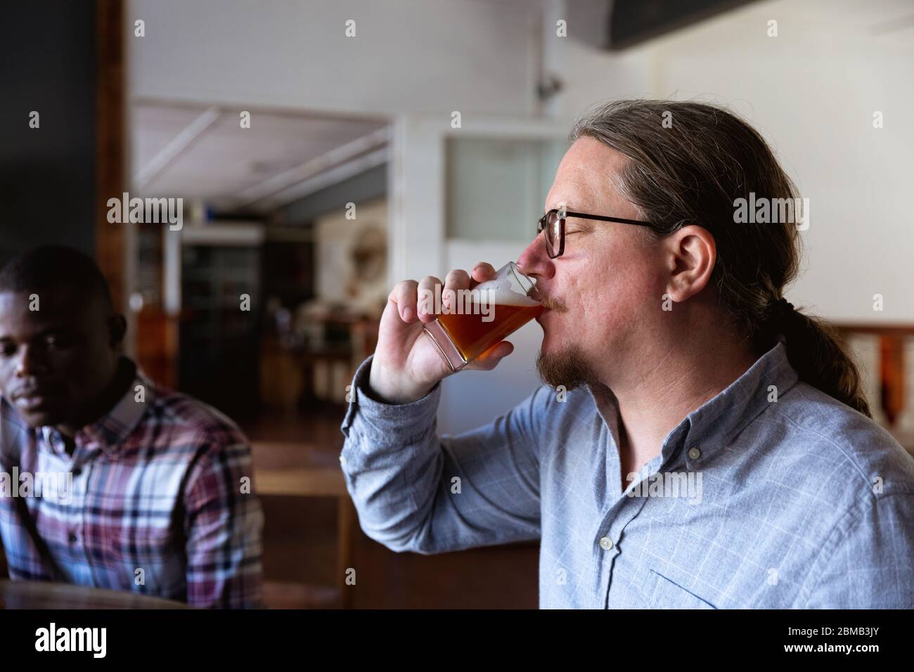 Caucasian man tasting beer in a brewery Stock Photo