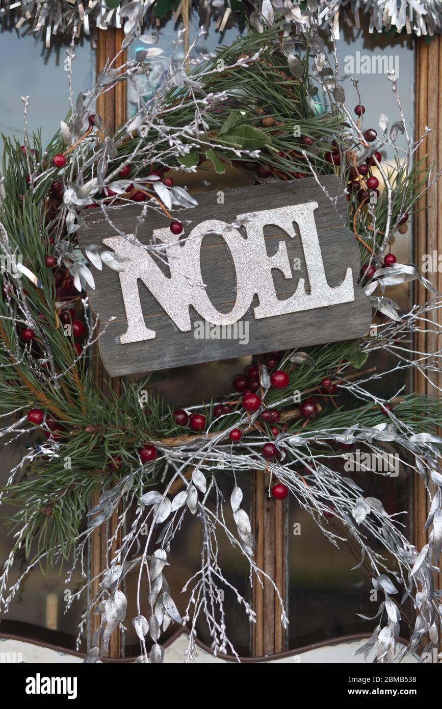 Christmas wreath and wooden noel sign Stock Photo