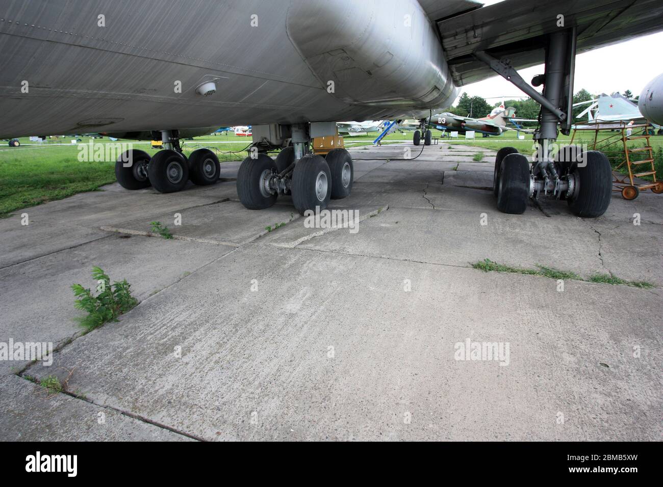 Broken pavement of the apron underneath an Ilyushin Il-86 due to the heavy weight of the plane (ACN vs. PCN) - Zhulyany Ukraine State Aviation Museum Stock Photo
