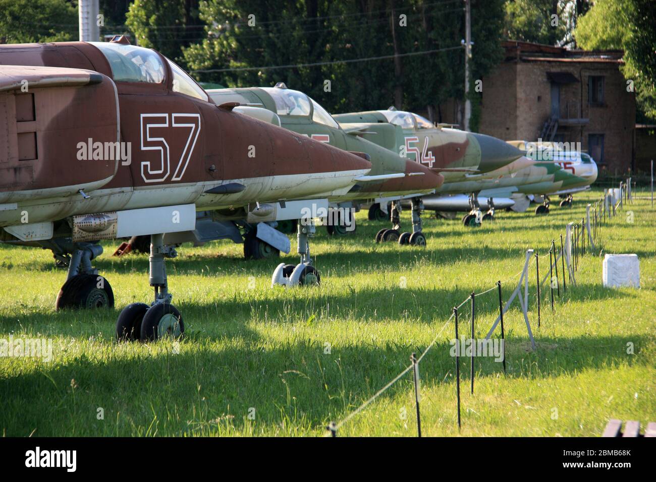 View of MiGs parked in line at the Ukraine State Aviation Museum - MiG-27 and MiG-23 in the foreground, MiG-21, MiG-19 and MiG-17 in the background Stock Photo