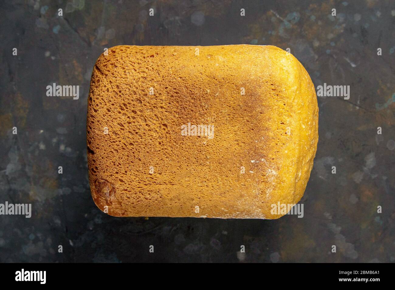 Fresh fragrant bread against a dark background. Assortment of baked bread on dark table background. Fresh fragrant bread on the table. Top views Stock Photo
