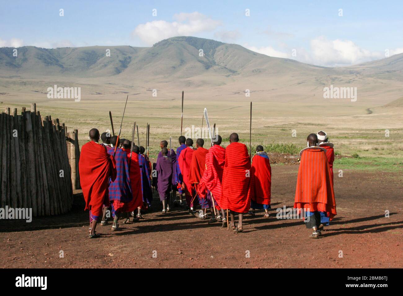 A group of Massai warriors armed with spears marching off Photographed in Tanzania Stock Photo