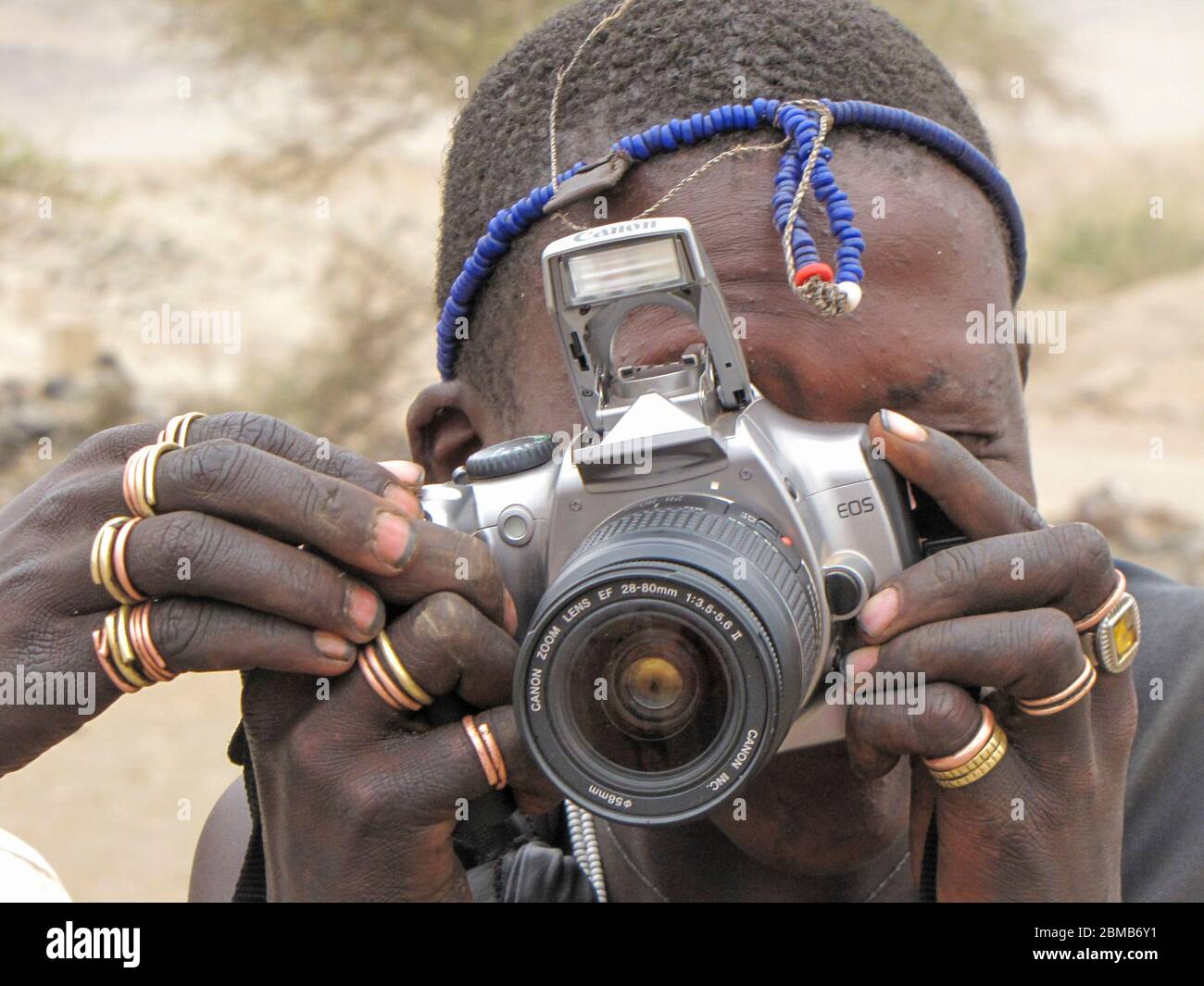 Portrait of a young Maasai tribesman with a camera. Maasai is an ethnic group of semi-nomadic people. Photographed in Tanzania Stock Photo