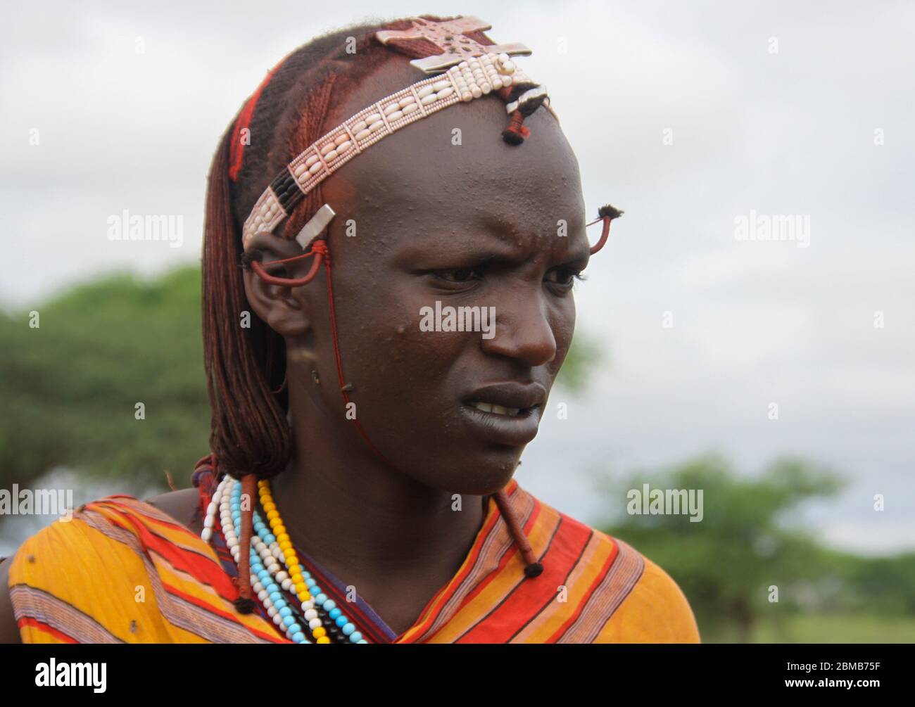 Portrait of a young Maasai tribesman. Maasai is an ethnic group of semi-nomadic people. Photographed in Tanzania Stock Photo