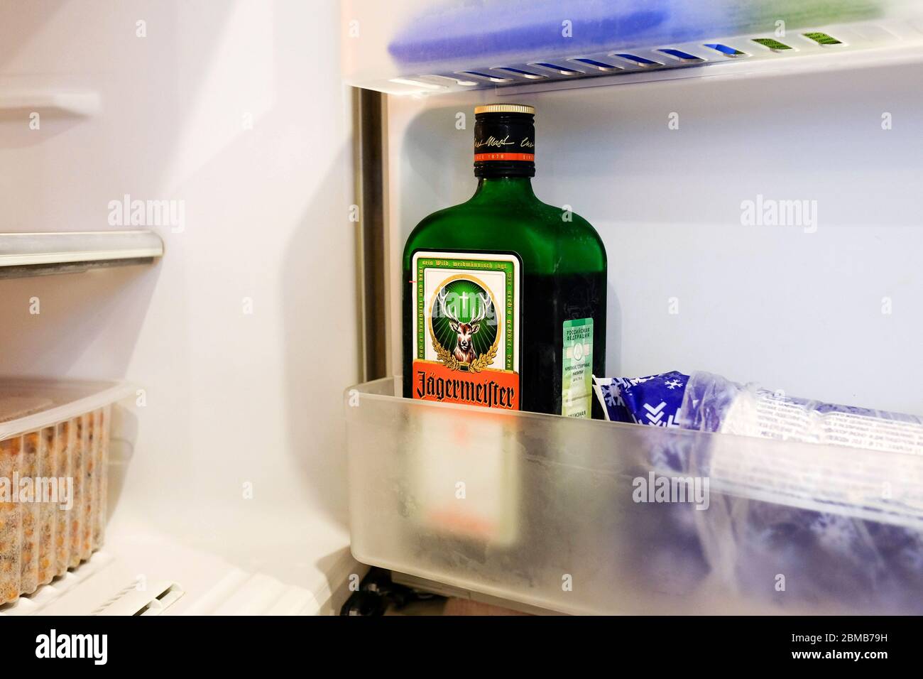 Jagermeister liquor in the freezer. Storage of a German alcoholic drink in the refrigerator at home. Stock Photo