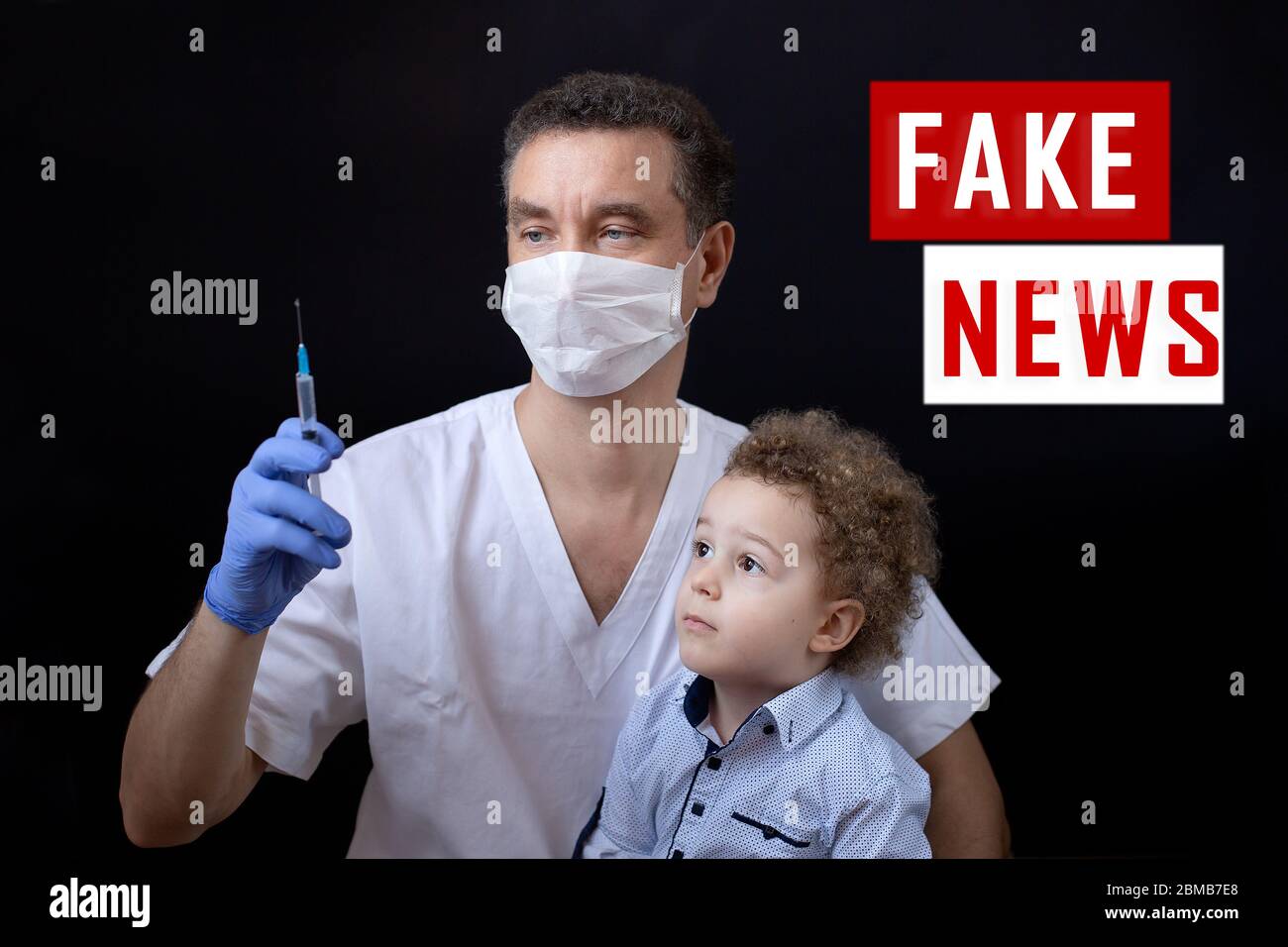 Doctor holding syringe with vaccine in hand and explaining to child Stock Photo
