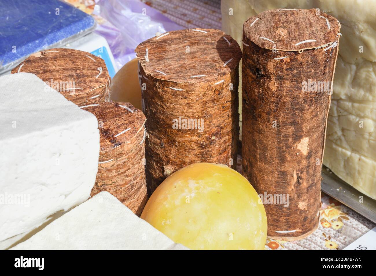 Branza de burduf, traditional sheep's milk cheese from south of Transilvania, Romanian specialty cheese, yellow round shape goat cheese balls homemade Stock Photo