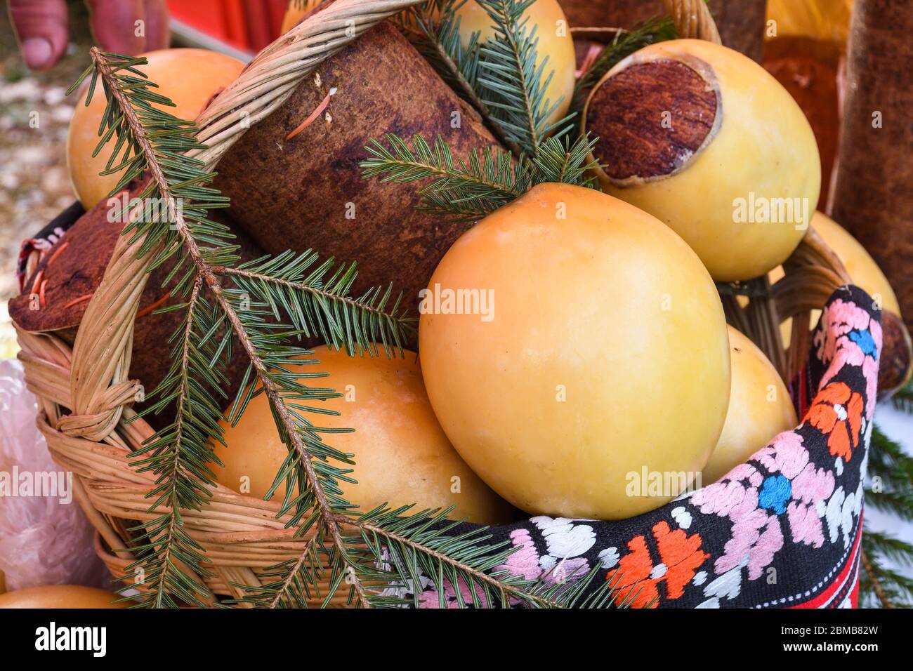 Branza de burduf, traditional sheep's milk cheese from south of Transilvania, Romanian specialty cheese, yellow round shape goat cheese balls homemade Stock Photo