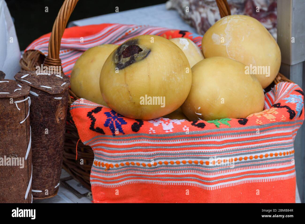 Branza de burduf, traditional sheep's milk cheese from south of Transilvania, Romanian specialty cheese, yellow round shape goat cheese balls homemade Stock Photo