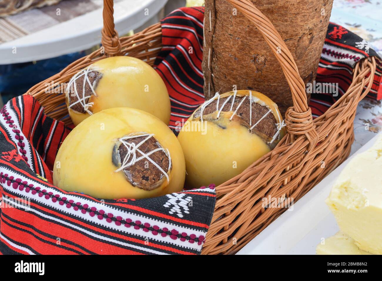 Branza de burduf, traditional sheep's milk cheese from south of Transilvania, Romanian specialty cheese, yellow round shape goat cheese balls homemade Stock Photo