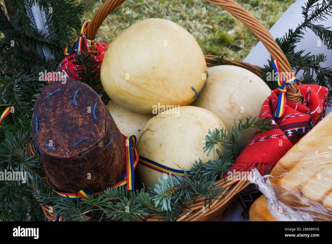 Branza de burduf, traditional sheep's milk cheese from south of Transilvania, Romanian specialty cheese, yellow round shape goat cheese balls homemade Stock Photo