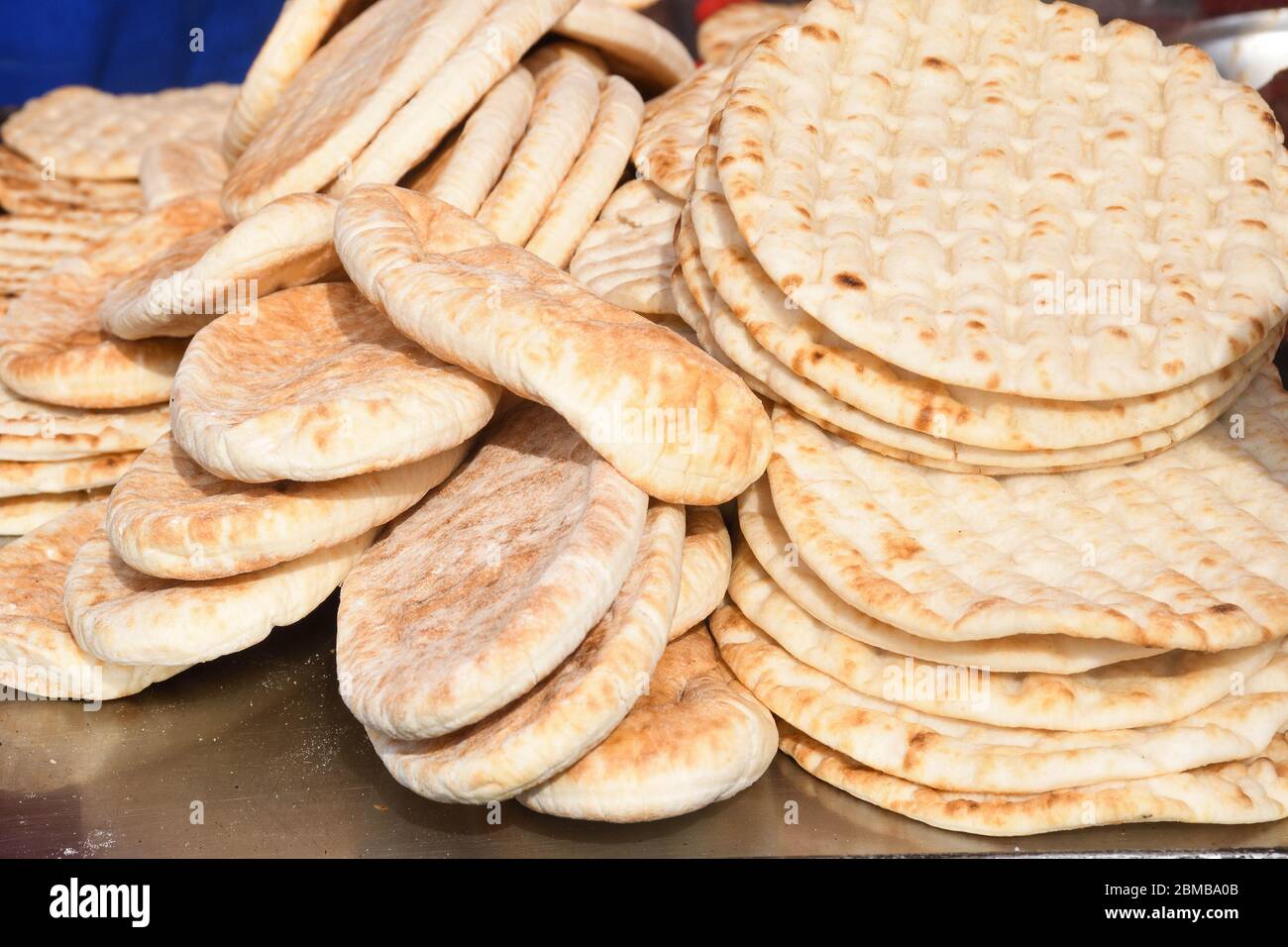 Pile of fresh pita flat bread. Gluten free lebanese or greek specialty.  Grilled or oven baked. Food festival for sale during outdoor event Stock  Photo - Alamy